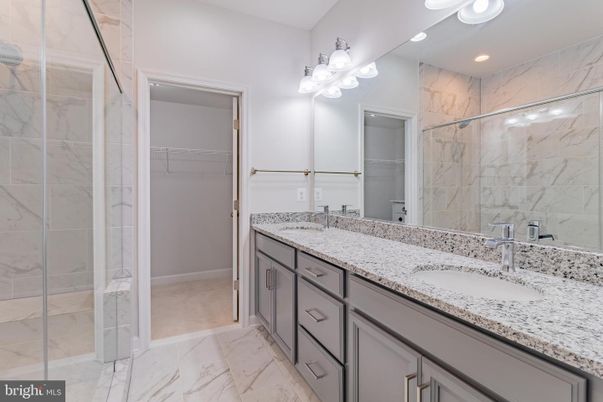 Bathroom, Dual Sink Vanities, Glass Shower, Interior, Marble, Marble Walls, Recessed Lighting, Walk-in Closets