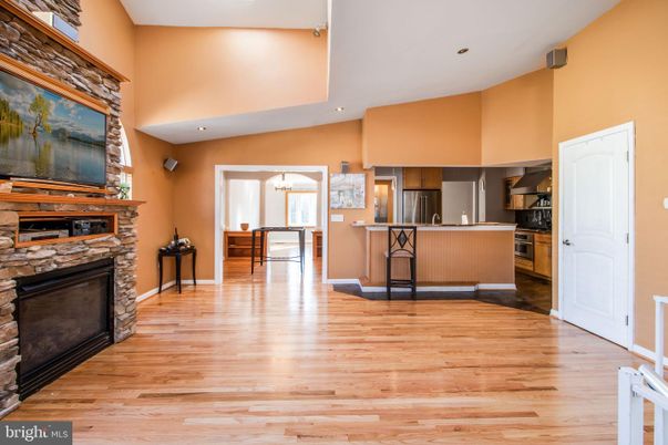 Chandelier, Fireplace, Interior, Kitchen, Pendant Lights, Recessed Lighting, Stainless Steel Appliances, Wood Texture Flooring