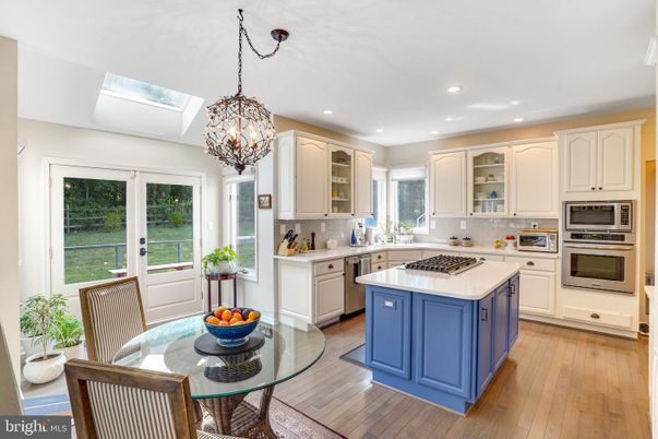 Chandelier, Dining room, Interior, Kitchen, Pendant Lights, Recessed Lighting, Stainless Steel Appliances, Wood Texture Flooring