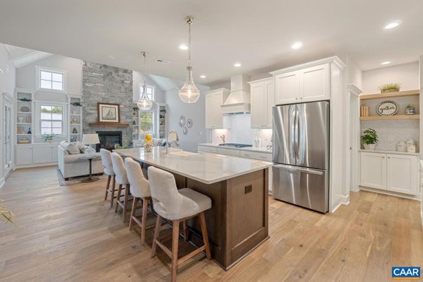 Fireplace, Interior, Kitchen, Living room, Pendant Lights, Recessed Lighting, Stainless Steel Appliances, Stone Walls, Wood Texture Flooring