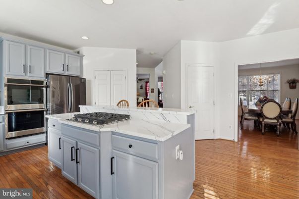 Chandelier, Dining room, Interior, Kitchen, Recessed Lighting, Stainless Steel Appliances, Wood Texture Flooring