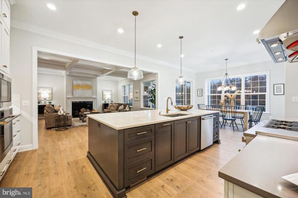 Chandelier, Dining room, Fireplace, Interior, Kitchen, Living room, Pendant Lights, Recessed Lighting, Stainless Steel Appliances, Wood Texture Flooring
