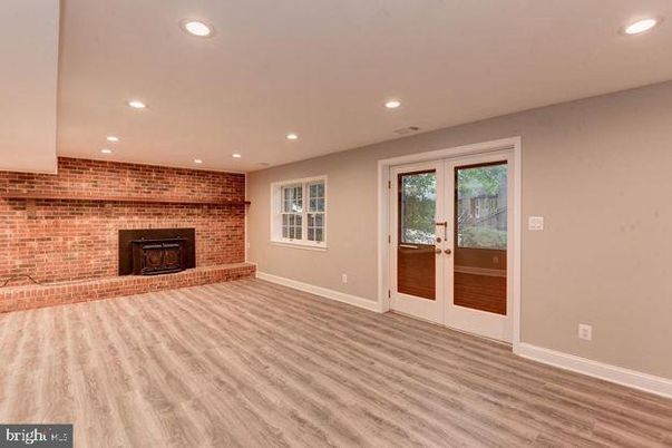 Empty room, Fireplace, Interior, Recessed Lighting, Stone Walls, Wood Texture Flooring