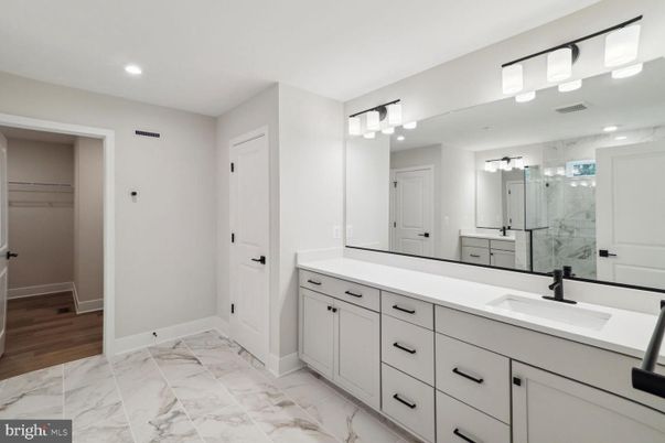 Bathroom, Dual Sink Vanities, Glass Shower, Interior, Marble, Marble Walls, Recessed Lighting, Walk-in Closets