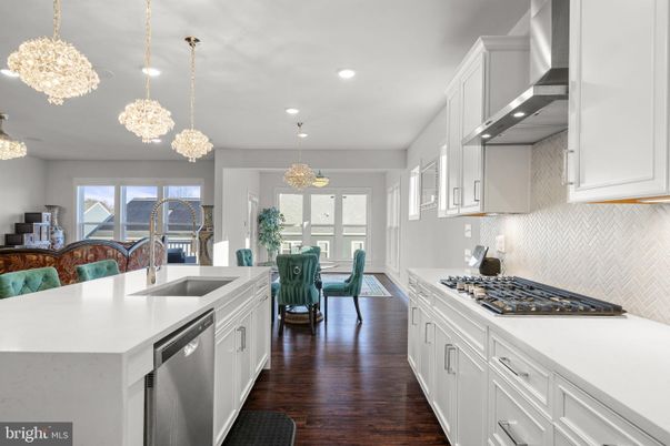 Chandelier, Dining room, Interior, Kitchen, Pendant Lights, Recessed Lighting, Stainless Steel Appliances, Wood Texture Flooring