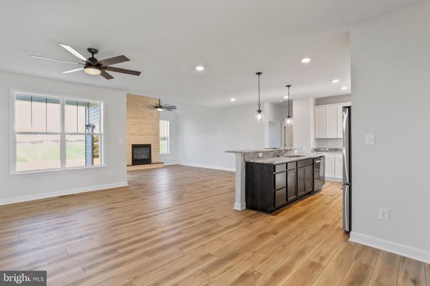 Empty room, Fireplace, Interior, Kitchen, Pendant Lights, Recessed Lighting, Stone Walls, Wood Texture Flooring