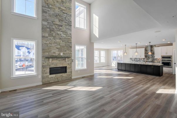 Fireplace, Interior, Kitchen, Pendant Lights, Recessed Lighting, Stainless Steel Appliances, Stone Walls, Wood Texture Flooring