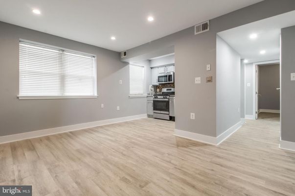 Empty room, Interior, Kitchen, Recessed Lighting, Stainless Steel Appliances, Wood Texture Flooring