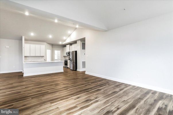 Empty room, Interior, Kitchen, Recessed Lighting, Stainless Steel Appliances, Wood Texture Flooring