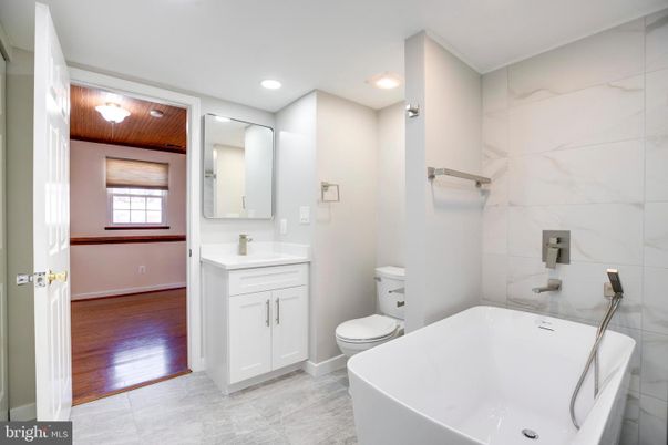 Bathroom, Dual Sink Vanities, Free Standing Baths, Interior, Marble, Marble Walls, Recessed Lighting, Wooden Ceilings, Wood Texture Flooring