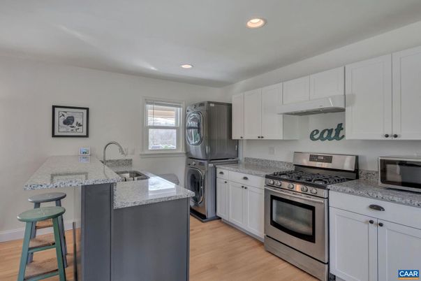 Interior, Kitchen, Recessed Lighting, Washer, Wood Texture Flooring