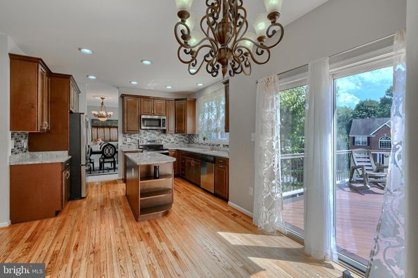 Chandelier, Dining room, Interior, Kitchen, Recessed Lighting, Stainless Steel Appliances, Wood Texture Flooring