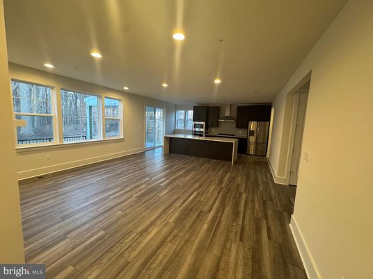 Empty room, Interior, Kitchen, Recessed Lighting, Stainless Steel Appliances, Wood Texture Flooring