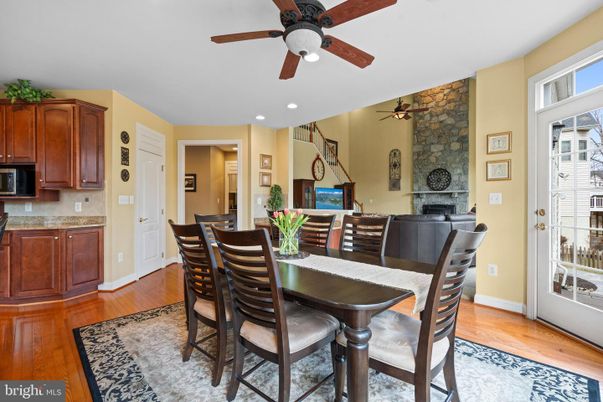 Dining room, Fireplace, Interior, Recessed Lighting, Stone Walls, Wood Texture Flooring