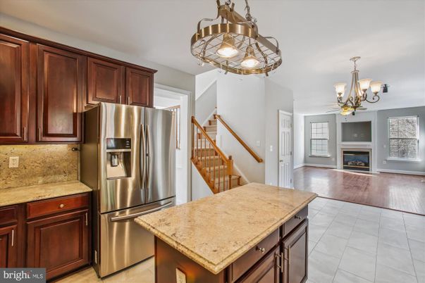 Chandelier, Fireplace, Interior, Kitchen, Stainless Steel Appliances, Wood Texture Flooring