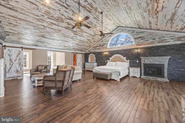 Bedroom, Fireplace, Interior, Living room, Pendant Lights, Stone Walls, Wood Texture Flooring