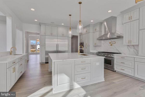 Interior, Kitchen, Marble Walls, Pendant Lights, Recessed Lighting, Stainless Steel Appliances, Wood Texture Flooring