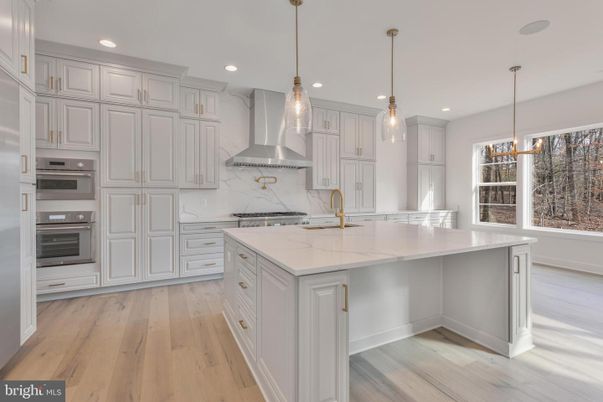 Interior, Kitchen, Marble Walls, Pendant Lights, Recessed Lighting, Stainless Steel Appliances, Wood Texture Flooring