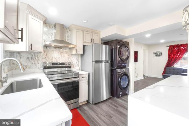Interior, Kitchen, Marble Walls, Recessed Lighting, Stainless Steel Appliances, Wood Texture Flooring