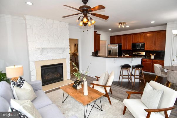 Dining room, Fireplace, Interior, Kitchen, Living room, Recessed Lighting, Stainless Steel Appliances, Stone Walls, Wood Texture Flooring