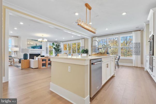 Chandelier, Dining room, Fireplace, Interior, Kitchen, Living room, Pendant Lights, Recessed Lighting, Stainless Steel Appliances, Wood Texture Flooring