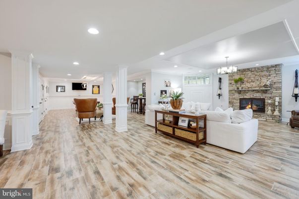 Chandelier, Fireplace, Interior, Living room, Recessed Lighting, Stone Walls, Wood Texture Flooring