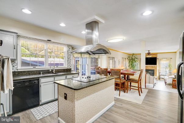 Dining room, Fireplace, Interior, Kitchen, Living room, Recessed Lighting, Stainless Steel Appliances, Wood Texture Flooring