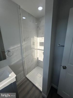 Bathroom, Glass Shower, Interior, Marble Walls, Recessed Lighting, Wood Texture Flooring