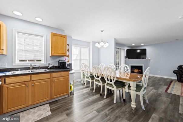 Chandelier, Dining room, Fireplace, Interior, Kitchen, Recessed Lighting, Wood Texture Flooring