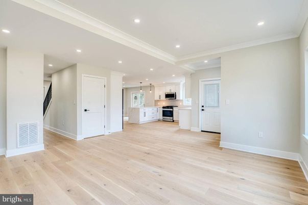 Empty room, Interior, Kitchen, Pendant Lights, Recessed Lighting, Stainless Steel Appliances, Wood Texture Flooring