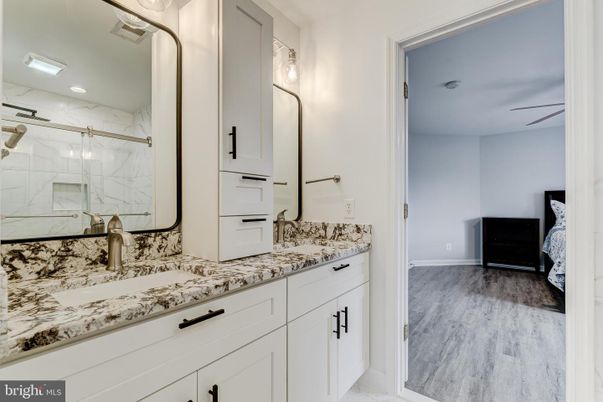 Bathroom, Dual Sink Vanities, Interior, Marble Walls, Recessed Lighting, Wood Texture Flooring