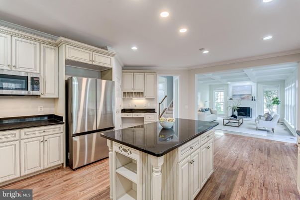 Fireplace, Interior, Kitchen, Living room, Recessed Lighting, Stainless Steel Appliances, Wood Texture Flooring