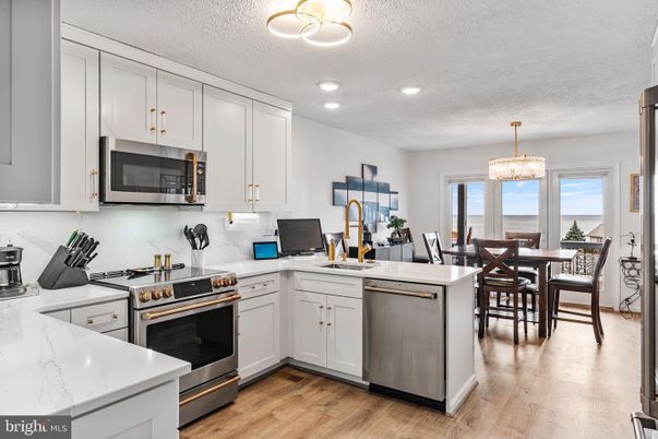 Chandelier, Dining room, Interior, Kitchen, Recessed Lighting, Stainless Steel Appliances, Wood Texture Flooring