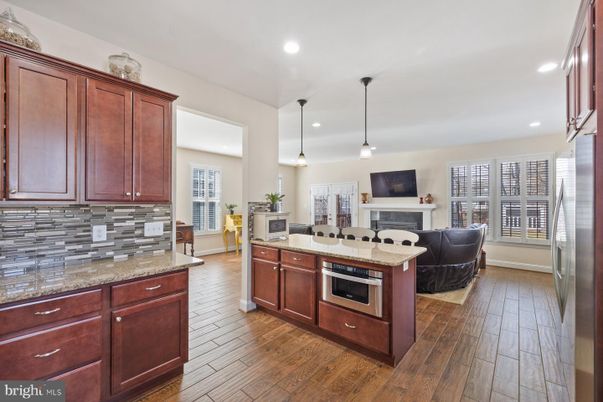Fireplace, Interior, Kitchen, Living room, Pendant Lights, Recessed Lighting, Stainless Steel Appliances, Wood Texture Flooring