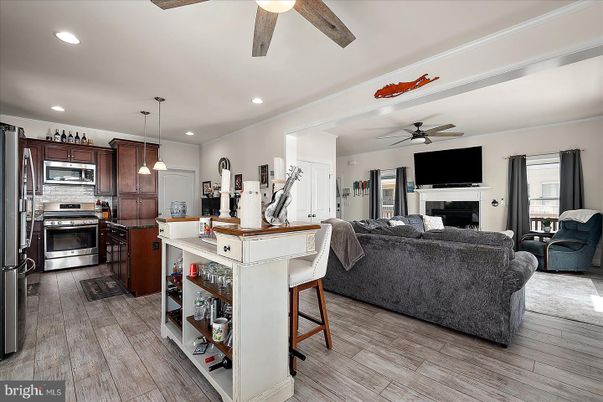 Fireplace, Interior, Kitchen, Living room, Pendant Lights, Recessed Lighting, Stainless Steel Appliances, Wood Texture Flooring