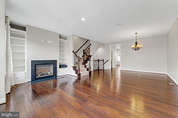 Chandelier, Empty room, Fireplace, Interior, Recessed Lighting, Wood Texture Flooring