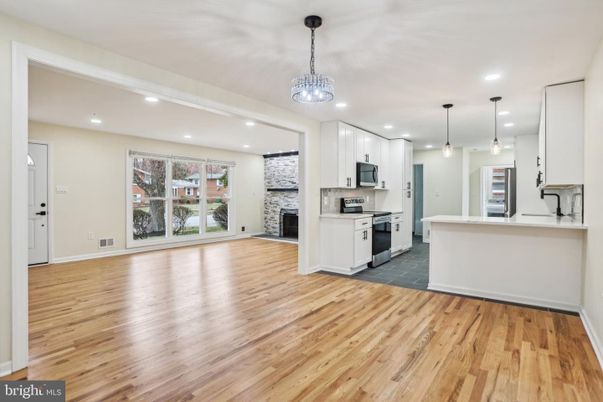 Empty room, Interior, Kitchen, Pendant Lights, Recessed Lighting, Stainless Steel Appliances, Wood Texture Flooring