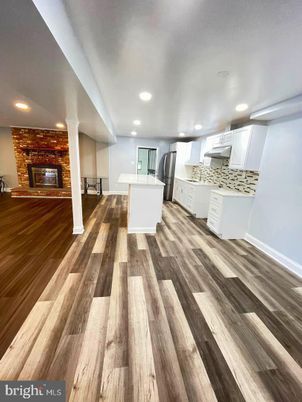 Fireplace, Interior, Kitchen, Recessed Lighting, Stone Walls, Wood Texture Flooring