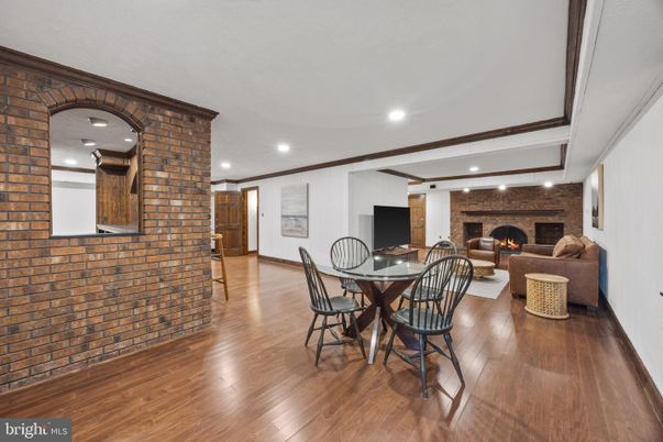 Dining room, Fireplace, Interior, Living room, Recessed Lighting, Stone Walls, Wood Texture Flooring
