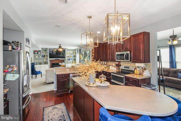 Dining room, Fireplace, Interior, Kitchen, Living room, Pendant Lights, Recessed Lighting, Stainless Steel Appliances, Wood Texture Flooring