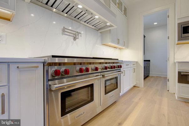 Interior, Kitchen, Marble Walls, Recessed Lighting, Stainless Steel Appliances, Wood Texture Flooring