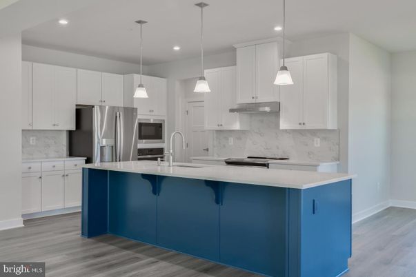 Interior, Kitchen, Marble Walls, Pendant Lights, Recessed Lighting, Stainless Steel Appliances, Wood Texture Flooring