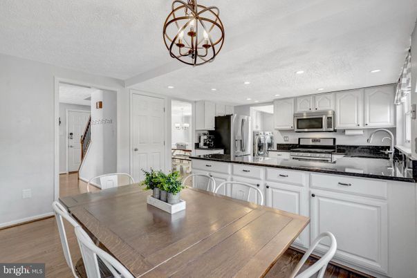Chandelier, Dining room, Interior, Kitchen, Recessed Lighting, Stainless Steel Appliances, Wood Texture Flooring