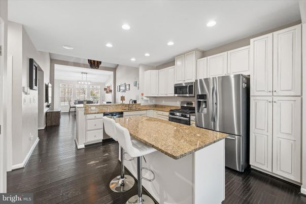 Chandelier, Dining room, Interior, Kitchen, Pendant Lights, Recessed Lighting, Stainless Steel Appliances, Wood Texture Flooring