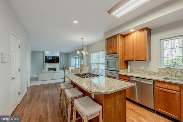 Chandelier, Dining room, Fireplace, Interior, Kitchen, Living room, Recessed Lighting, Stainless Steel Appliances, Wood Texture Flooring