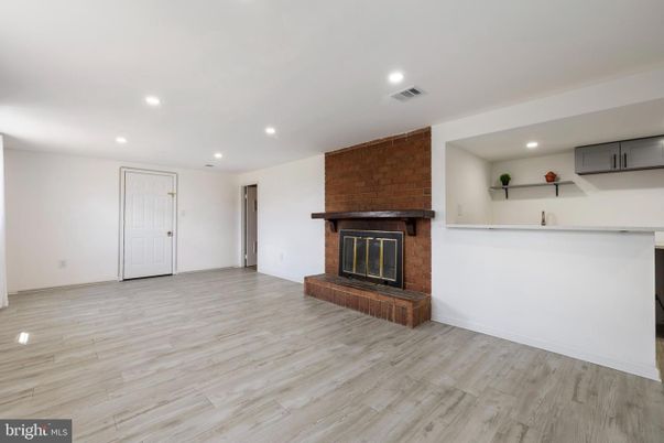 Empty room, Fireplace, Interior, Recessed Lighting, Stone Walls, Wood Texture Flooring