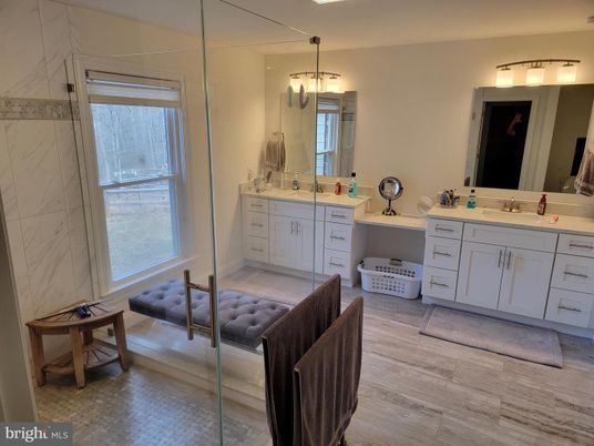 Bathroom, Dual Sink Vanities, Glass Shower, Interior, Marble Walls, Wood Texture Flooring