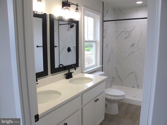 Bathroom, Dual Sink Vanities, Interior, Marble Walls, Recessed Lighting, Wood Texture Flooring