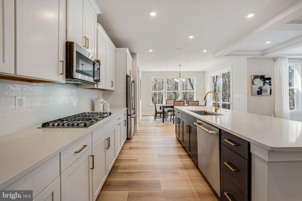 Chandelier, Dining room, Interior, Kitchen, Pendant Lights, Recessed Lighting, Stainless Steel Appliances, Wood Texture Flooring