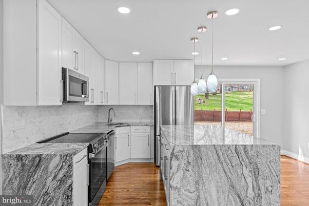 Interior, Kitchen, Marble Walls, Pendant Lights, Recessed Lighting, Stainless Steel Appliances, Wood Texture Flooring